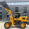 Yellow heavy-duty telehandler with a raised bucket attachment in front of a dark gray office building; brand name MASSIVE visible on the arm.